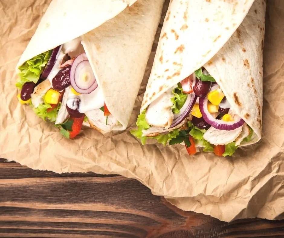 two chicken tex mex wraps with corn, beans, onions, chicken, and lettuce for working man