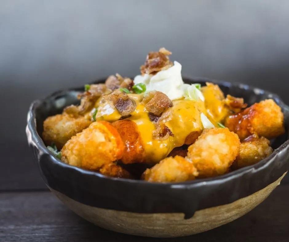 bowl of tater tots with taco toppings