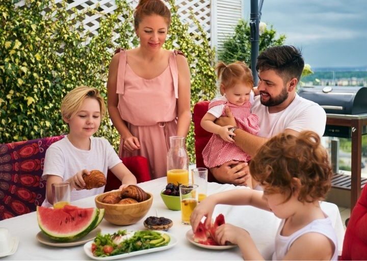 family on vacation eating lunch on a patio