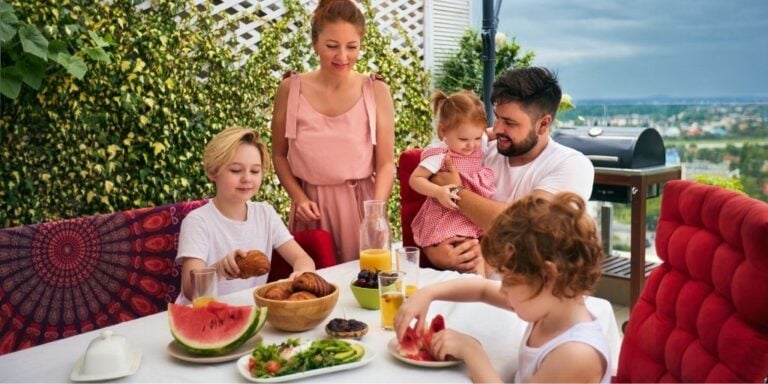 family on vacation eating lunch on a patio