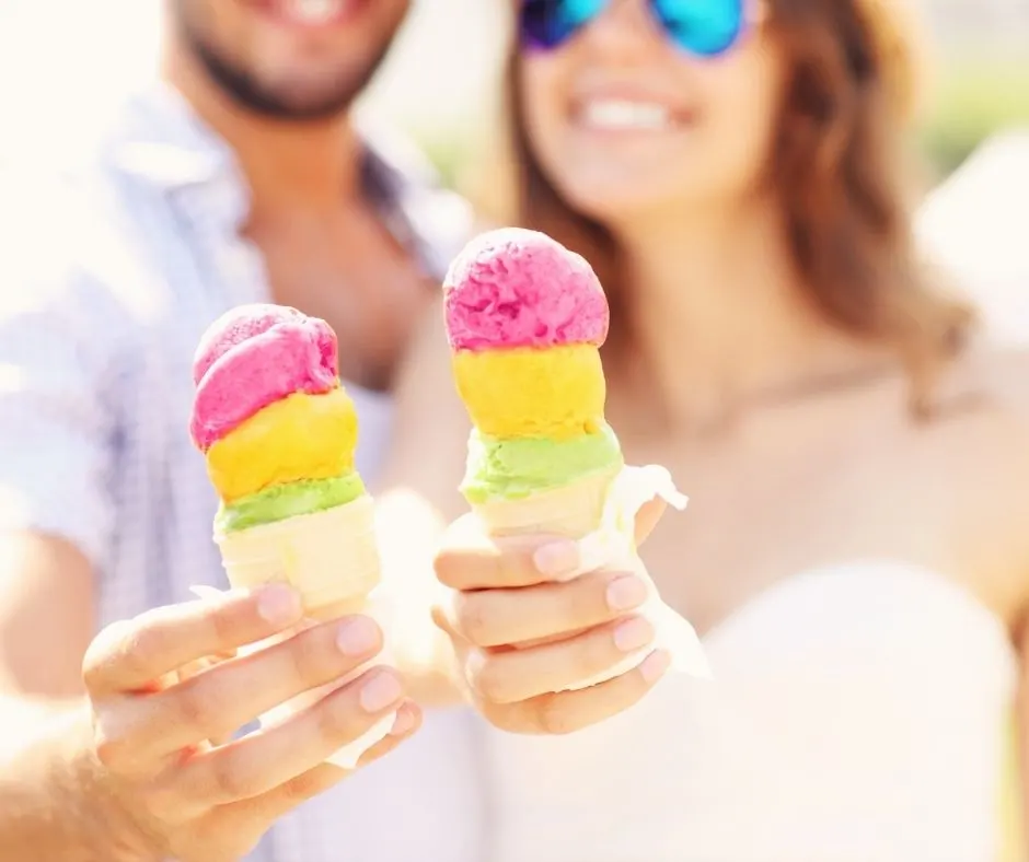adult couple smiling, with colorful ice cream cones
