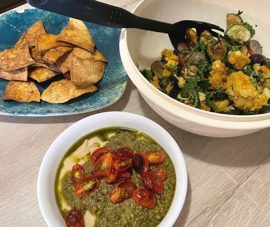 One of our favorite daniel fast dinner menu with salsa verde panzanella and corn muffins, white bean hummus with pesto and roasted cherry tomatoes, and homemade baked tortilla chips