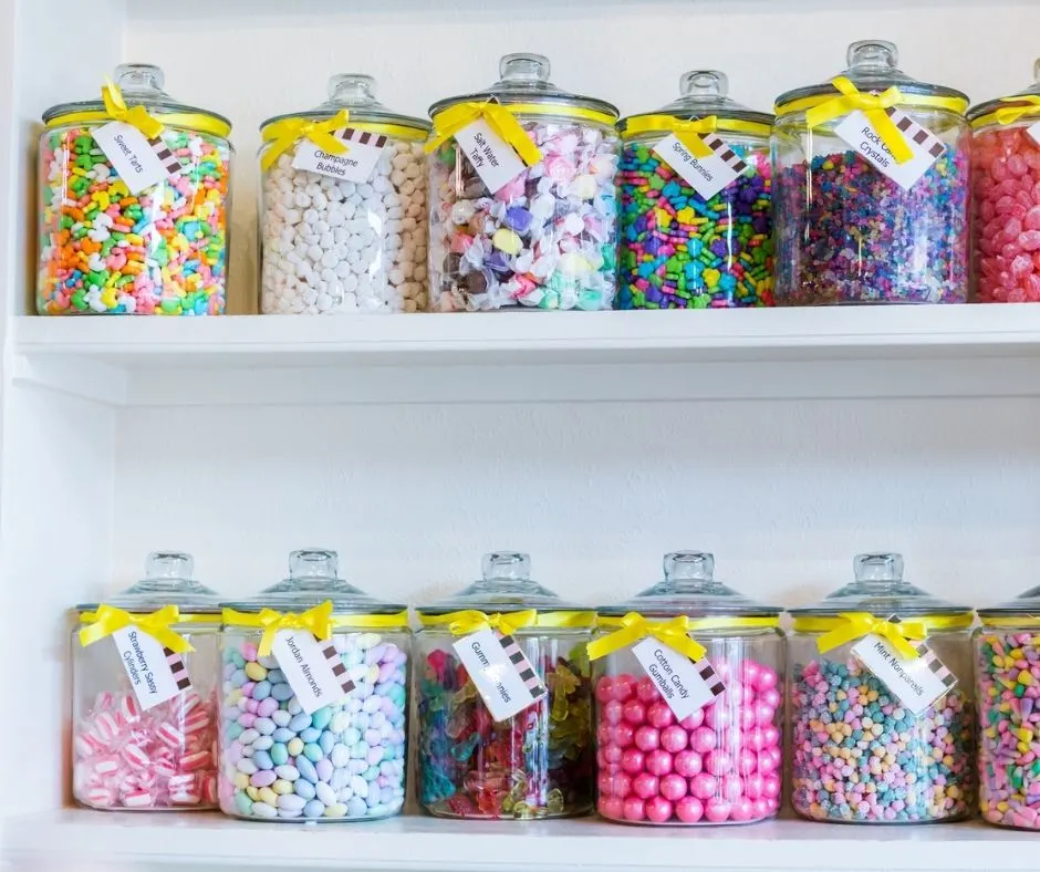 lines of glass candy jars on shelf at a boutique candy store