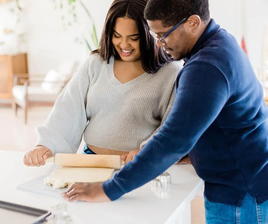 couple having fun baking a pie together in the kitchen