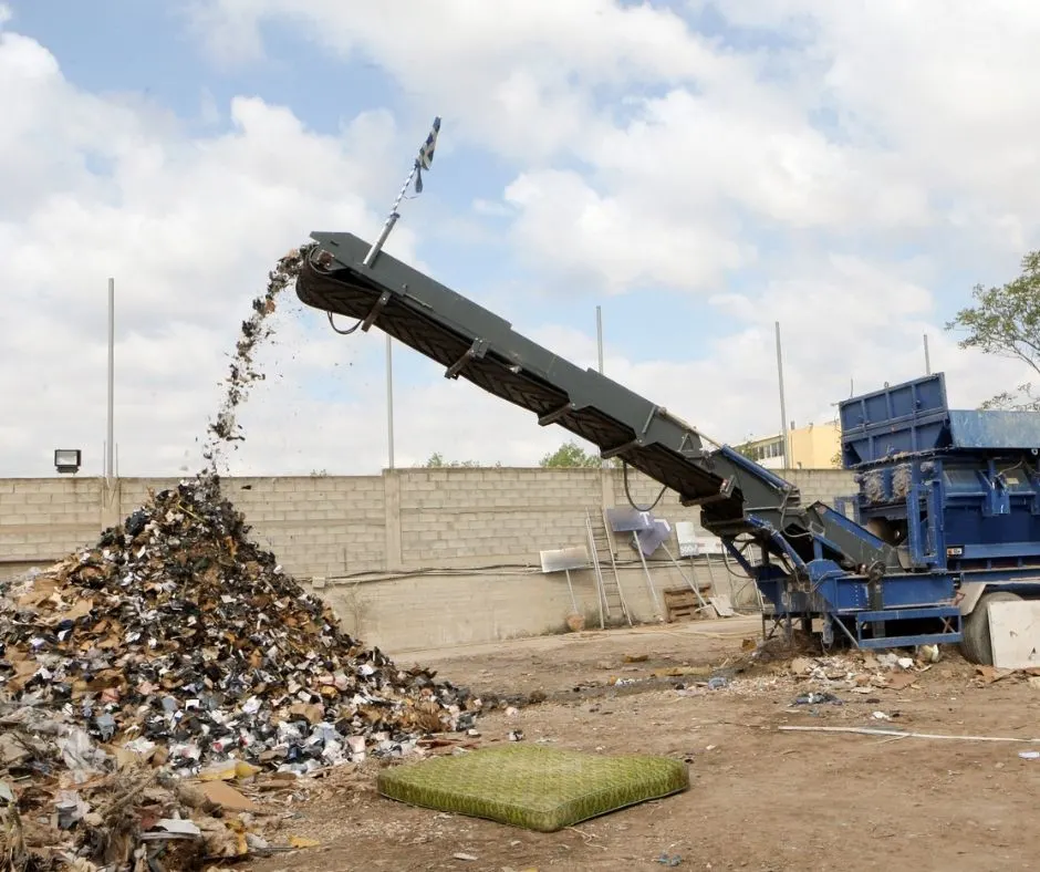 blue scrap metal shredder on scrap metal yard property