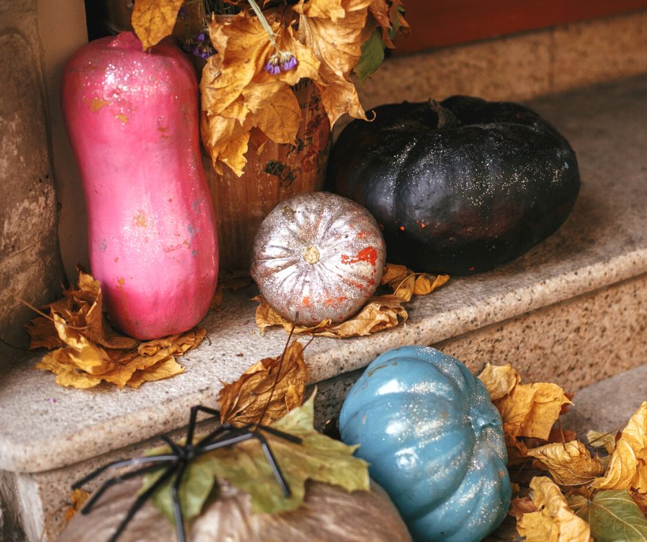painted gourds, pink, blue, and black on steps