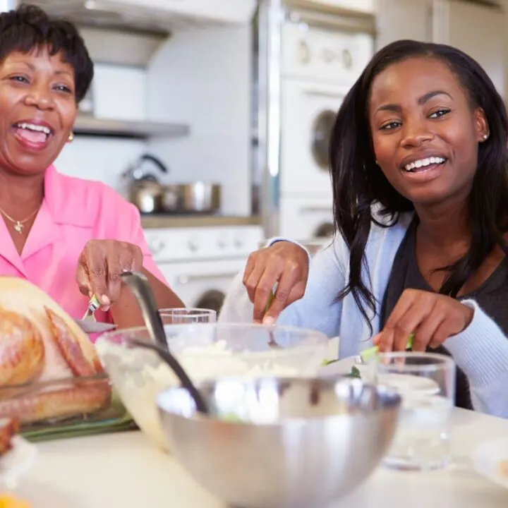 two adult women having fun at thanksgiving table with an activity