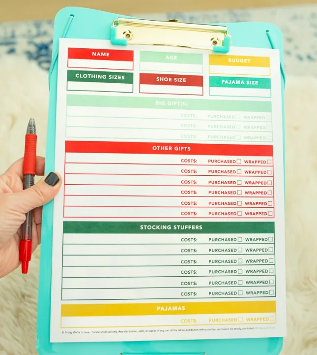 green, red, light green, and yellow Christmas gift list planner for one person, on blue clipboard