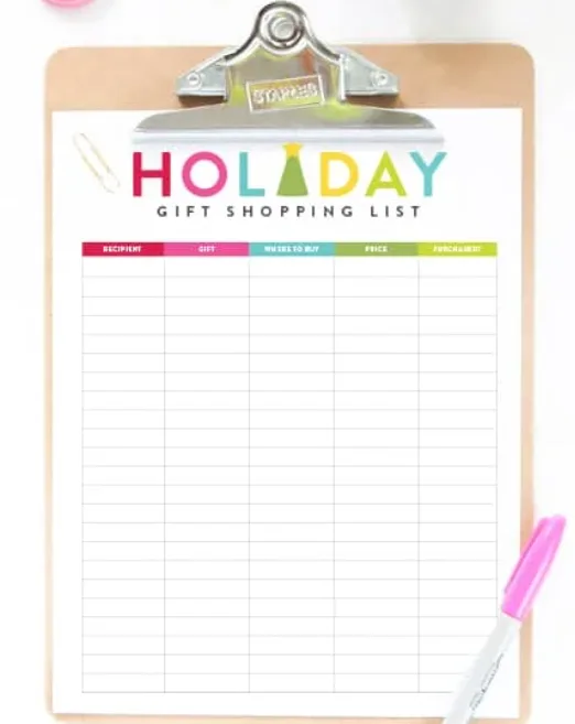 holiday gift shopping list with colorful word Holiday at the top, on clipboard
