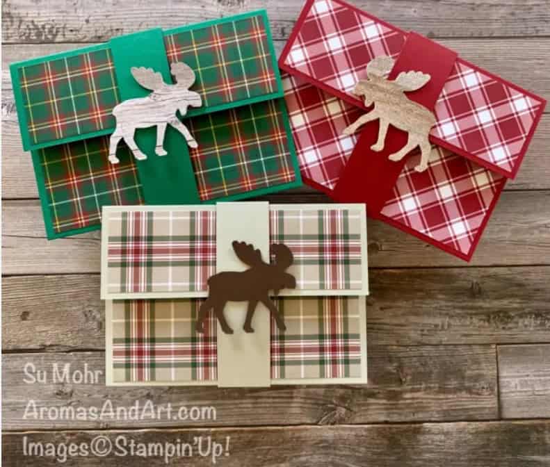 three moose and plaid money card holders on wooden table