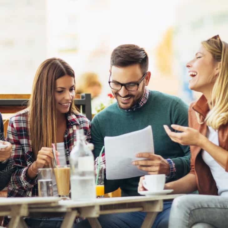 group of adults having fun playing free printable fall game at table