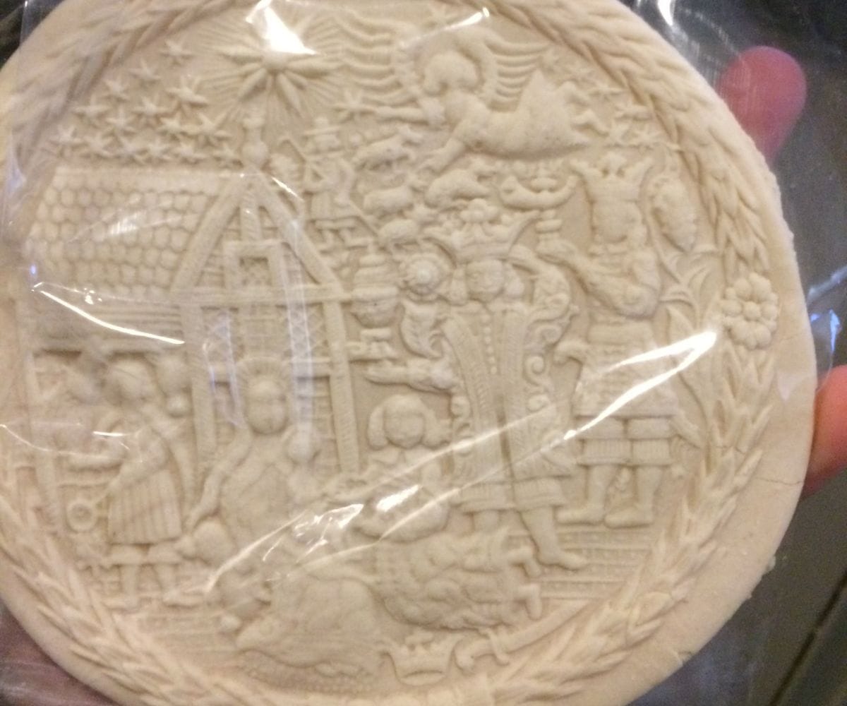 author holding intricately detailed cookie presenting the nativity scene