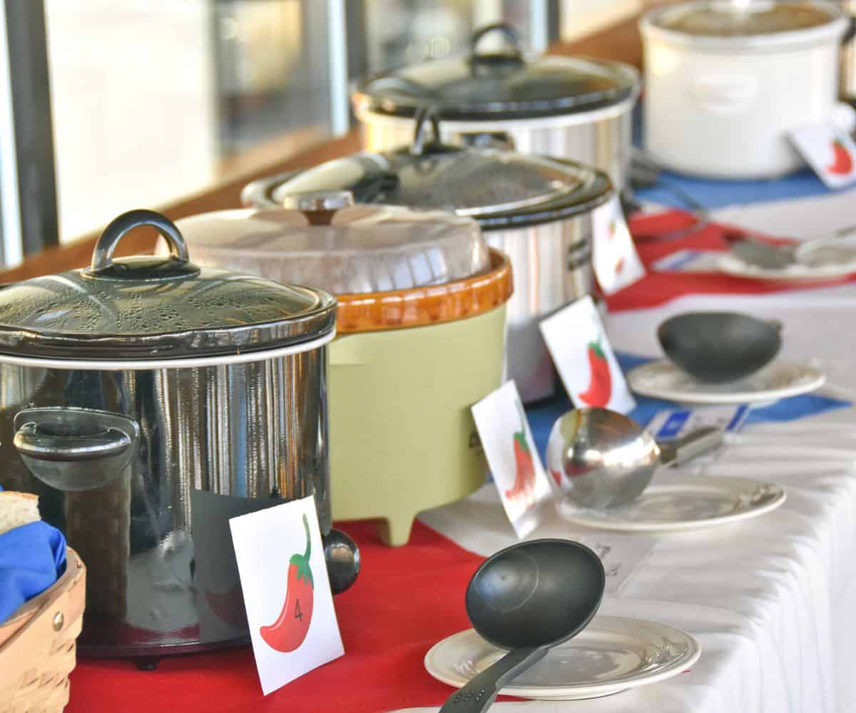 line of crockpots filled with chili for chili cook off judging