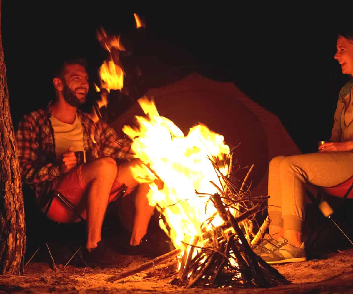 adults sitting around fire getting ready for pudgy pie contest