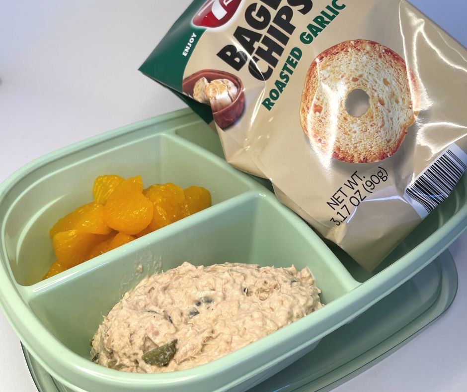 bagel chips, tunafish salad, and mandarin oranges in 3-compartment green container
