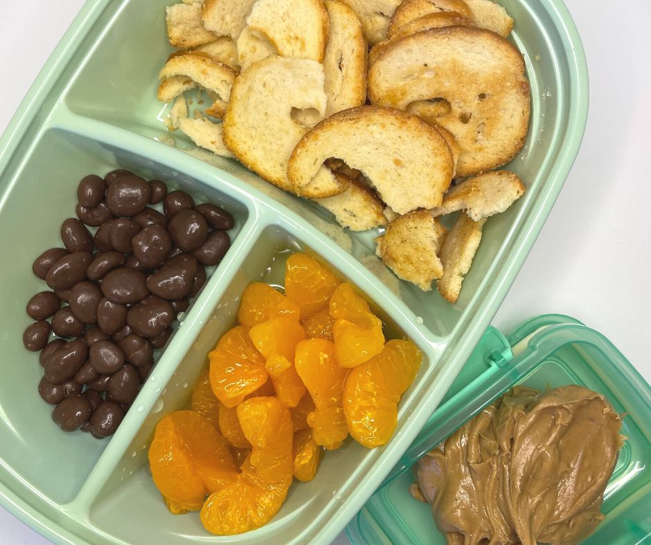 bagel chips, chocolate raisins, mandarin oranges and peanut butter in dollar tree lunch container