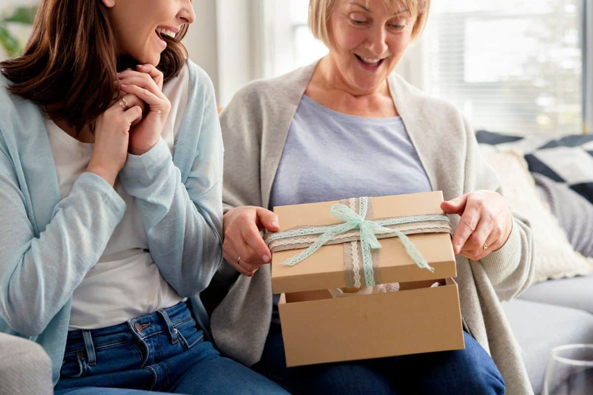 adult daughter handing Mom gift from Dollar Tree