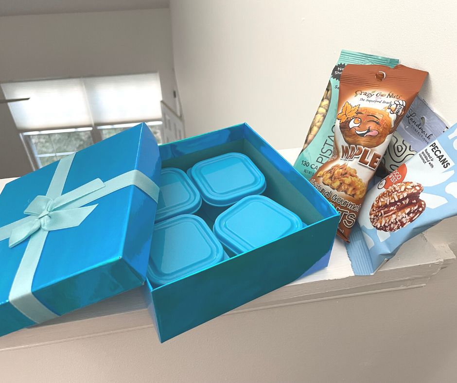 bright blue gift box with four blue-lidded containers inside for four different nut packages