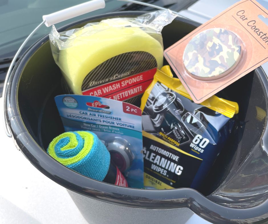 black wash bucket filled with car products on hood of car
