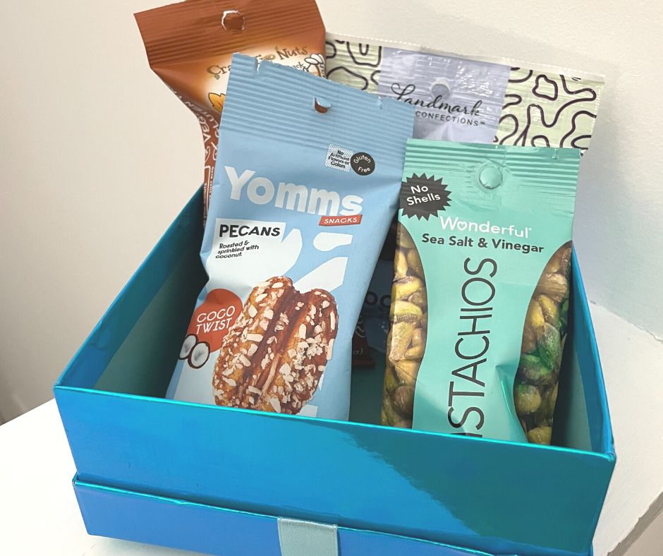 four packages of snack nuts in bright blue gift box