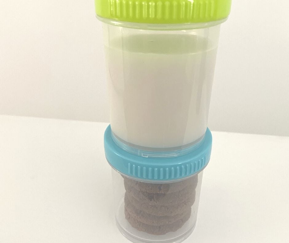 stacked baby food containers from Dollar Tree with almond milk on top and ginger snaps on bottom