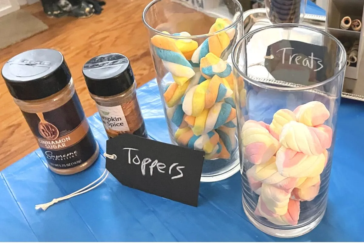 two glass jars filled with unicorn marshmallows, plus pumpkin pie spice and cinnamon sugar shakers