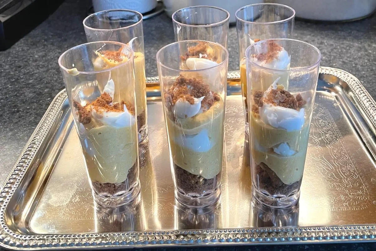 six dessert shooters on kitchen counter on silver tray