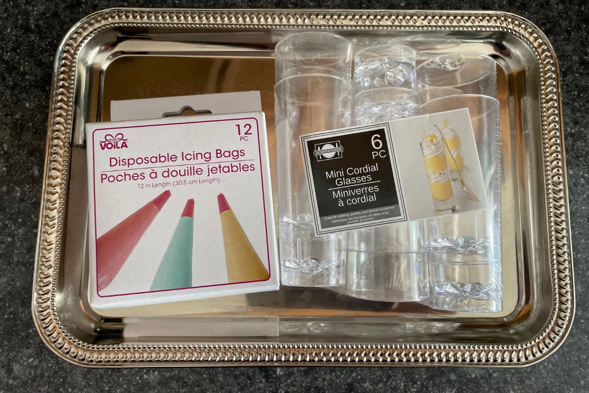 silver tray with dessert shooter mini glasses and disposable icing bags