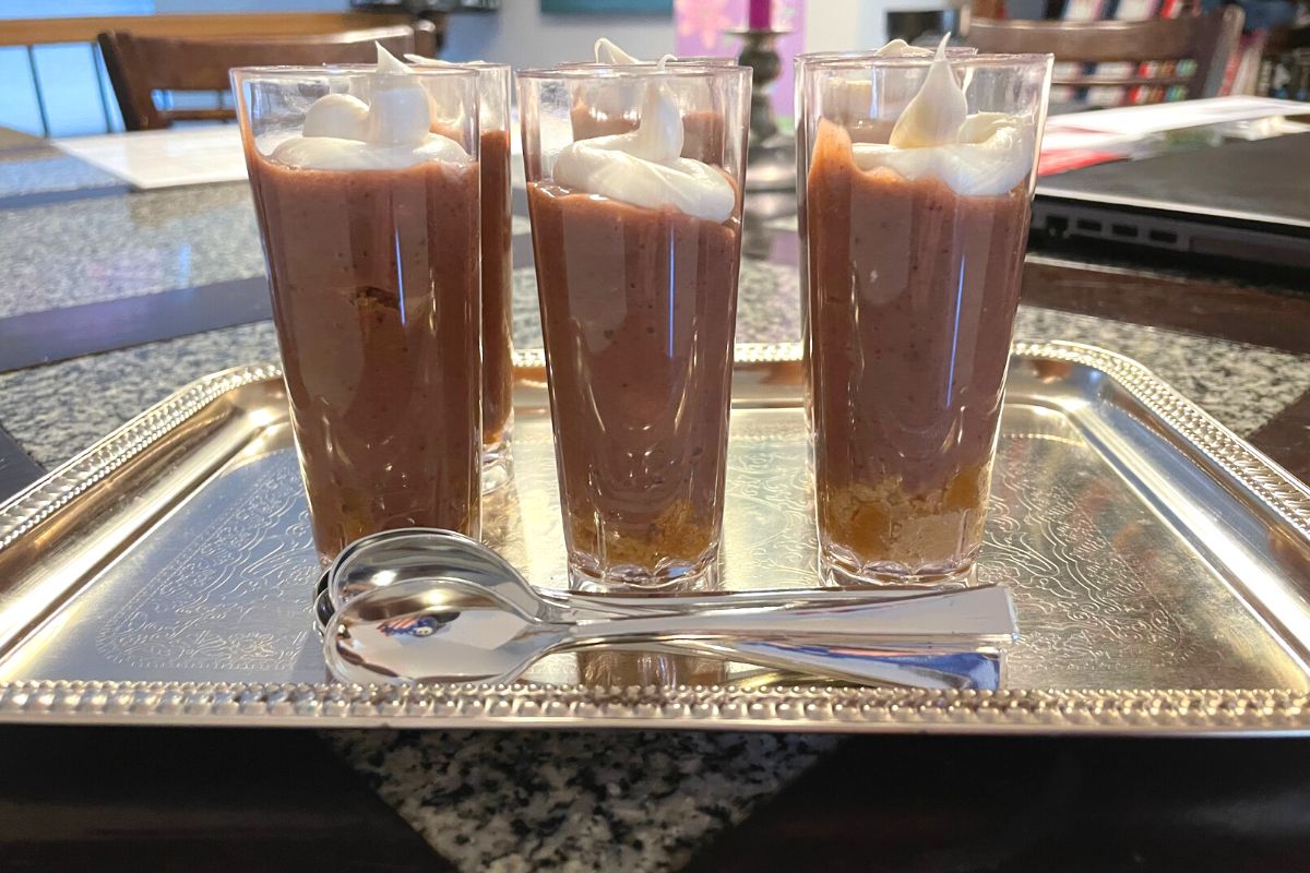 silver tray with six dessert shooters and two silver plastic spoons