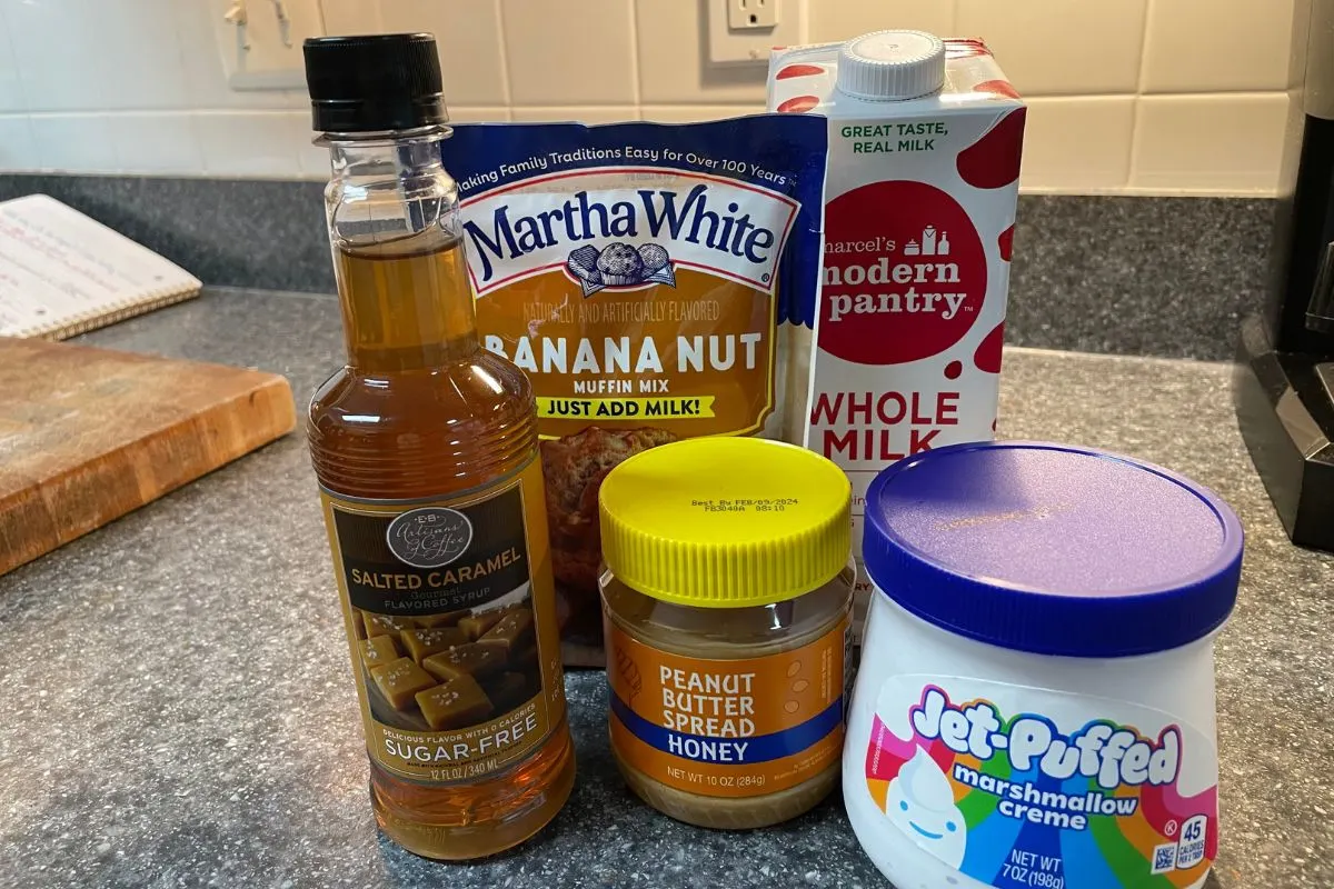 peanut butter, marshmallow fluff, banana nut muffin mix, and milk on kitchen counter