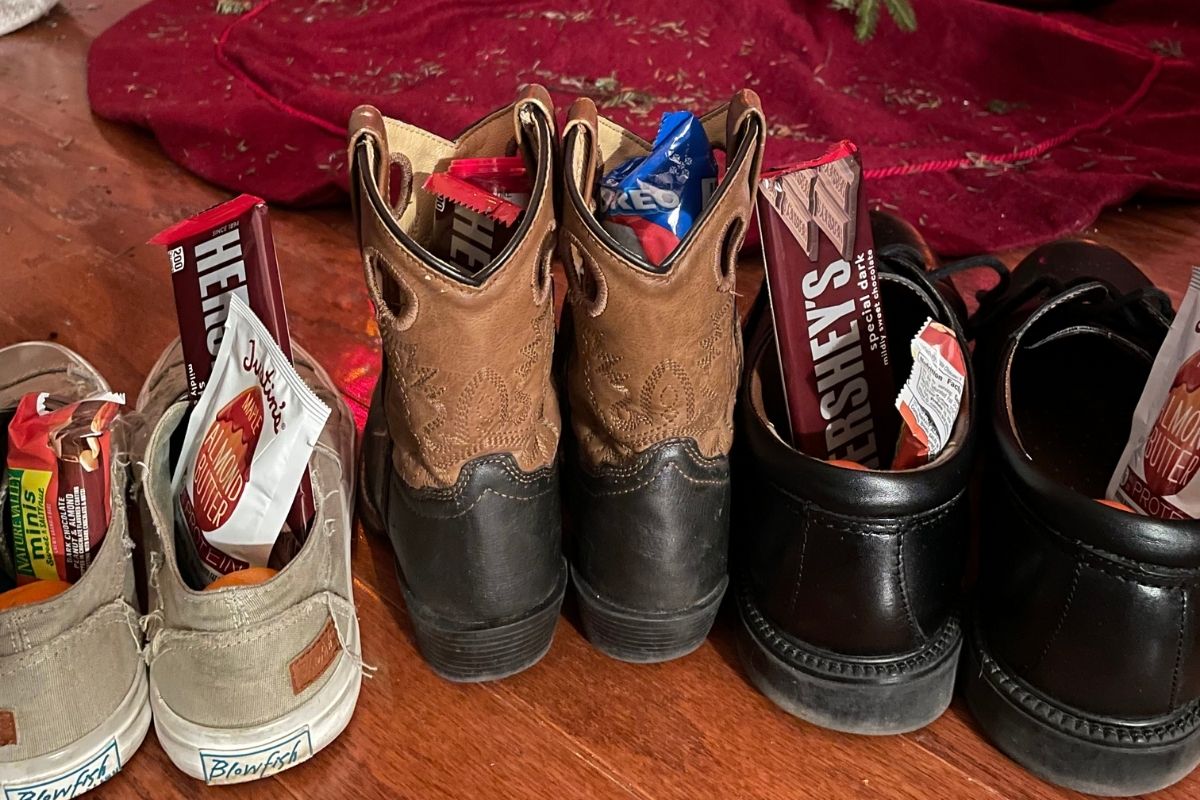 three pairs of shoes filled with Justin's almond butter, dark chocolate, granola bars, etc.