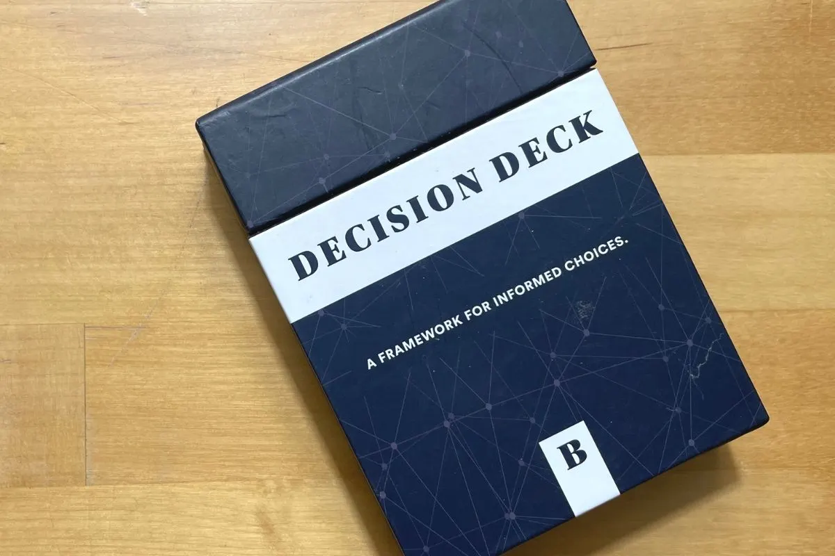 mostly black box of Decision Deck cards on light wooden table