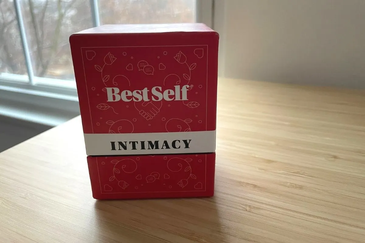 red and white deck of Best Self Intimacy conversation starter cards for married couples on bamboo desk