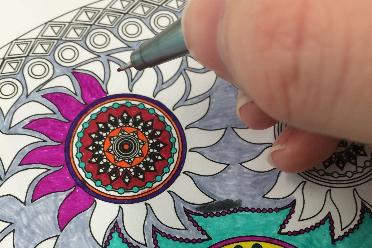 closeup of author's hand coloring in Mandala