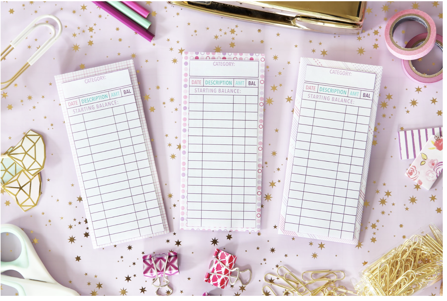 pink and white vertical envelopes with columns and rows to record data, on pink starry flatlay