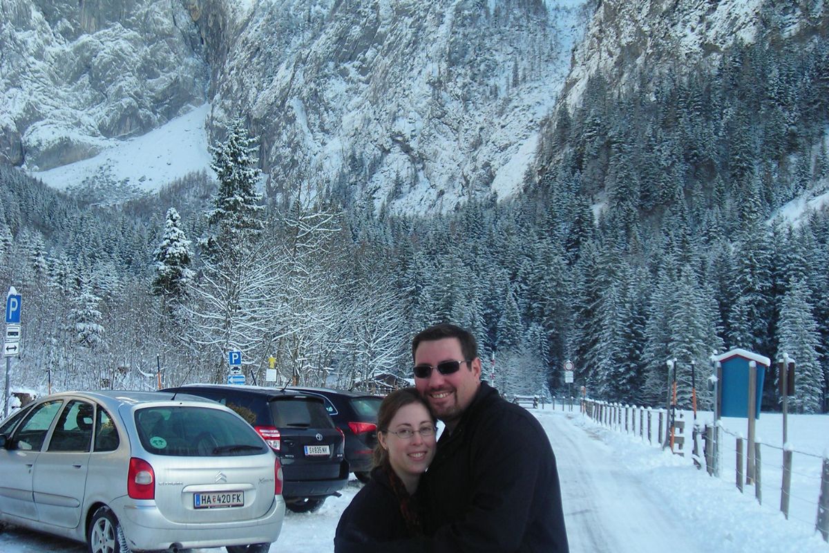 author and husband newlyweds in front of snow-covered alps