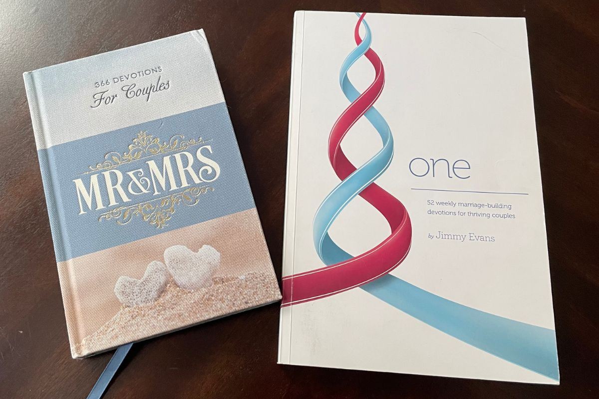 One and Mr. & Mrs. Bible devotionals for couples on dark table