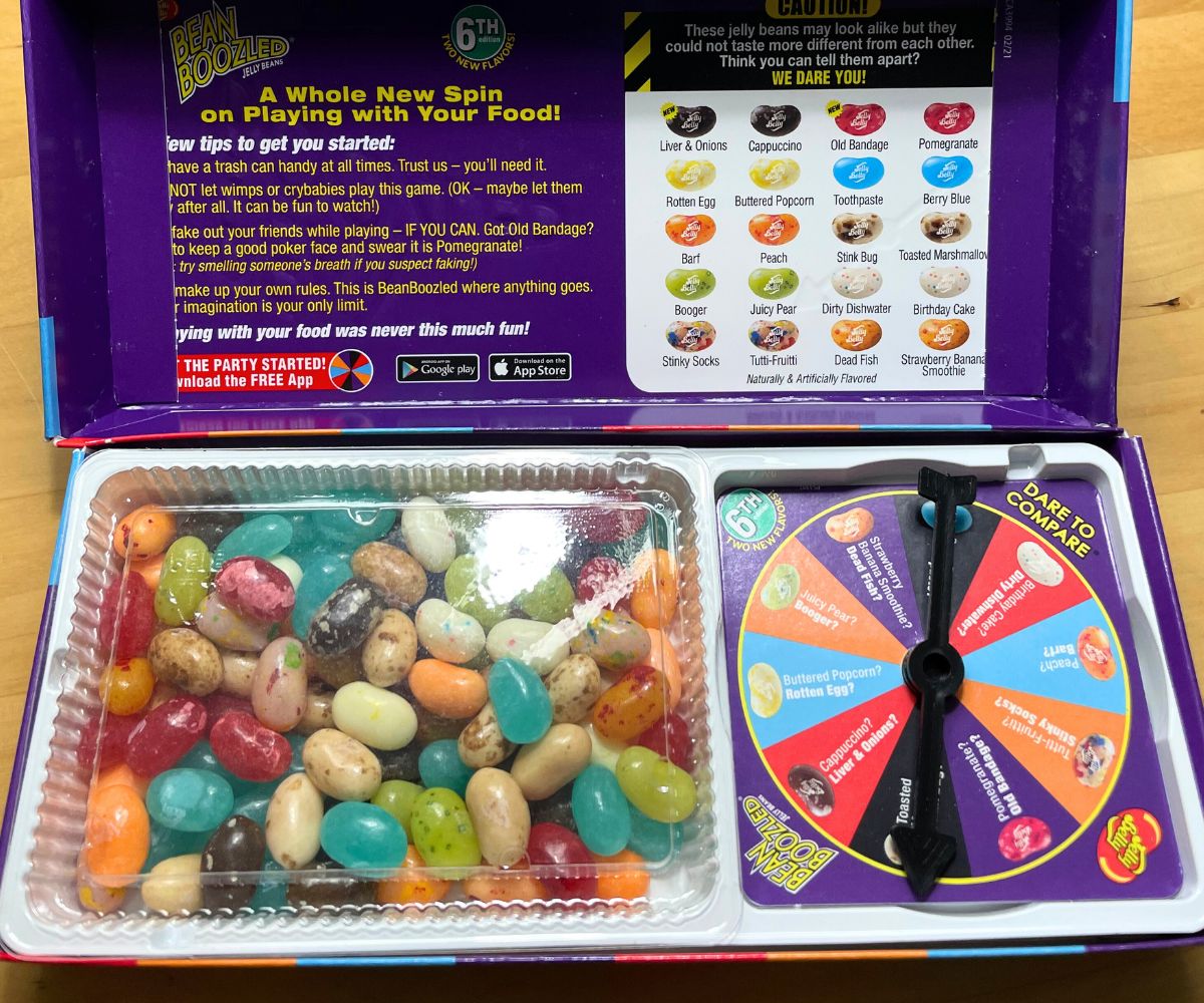 Dark purple box filled with jelly belly beans on one side, and a spinner on the other
