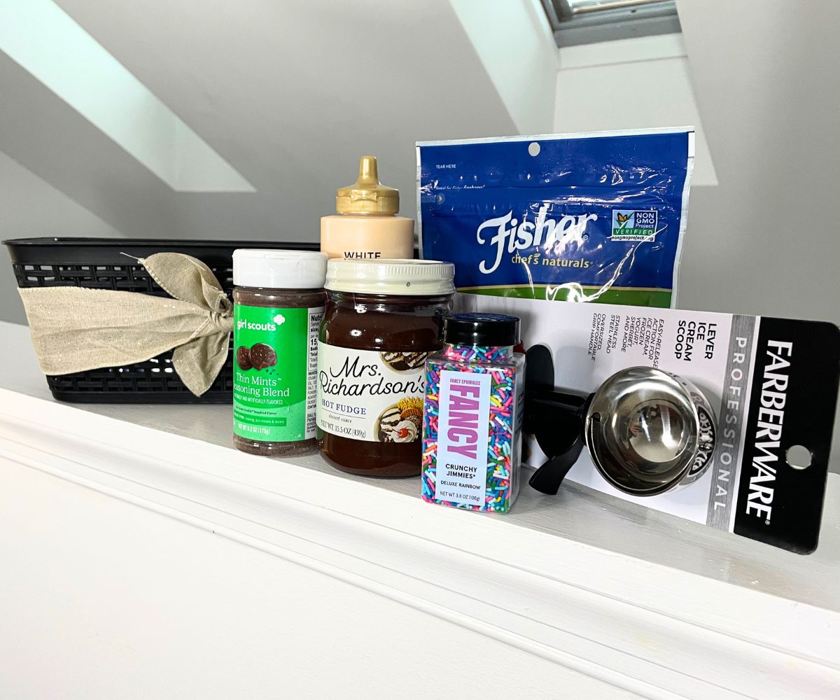 all of the sundae products in front of the black basket with ribbon on a white background