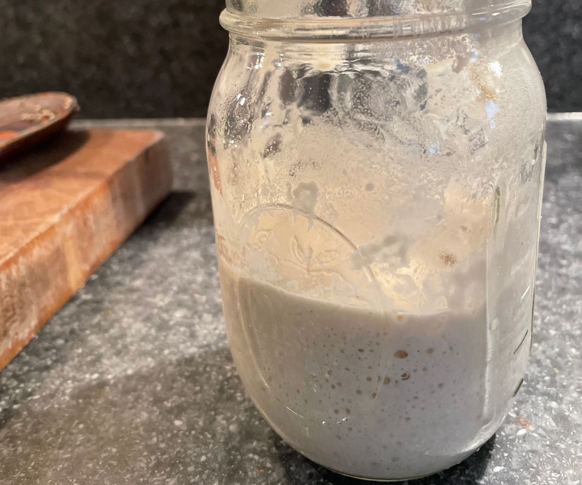 mason jar with bubble sourdough starter throughout