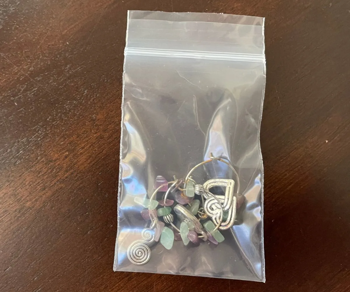 three wine charmers with green and purple beads in small baggie