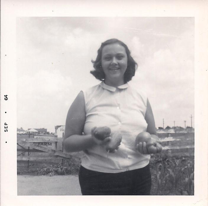 My grandmother holding vegetables from their garden