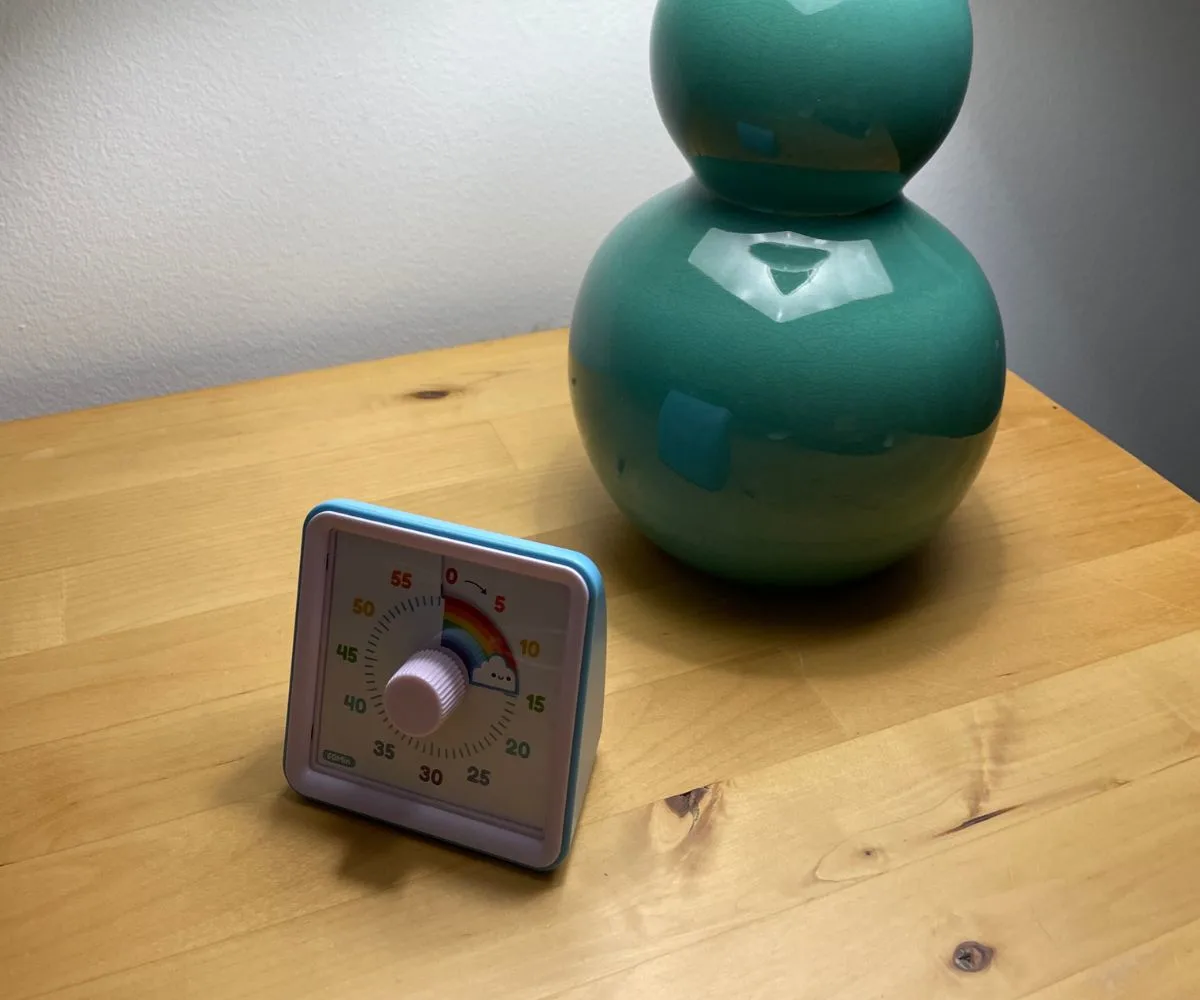 rainbow pomodoro timer in front of turquoise lamp