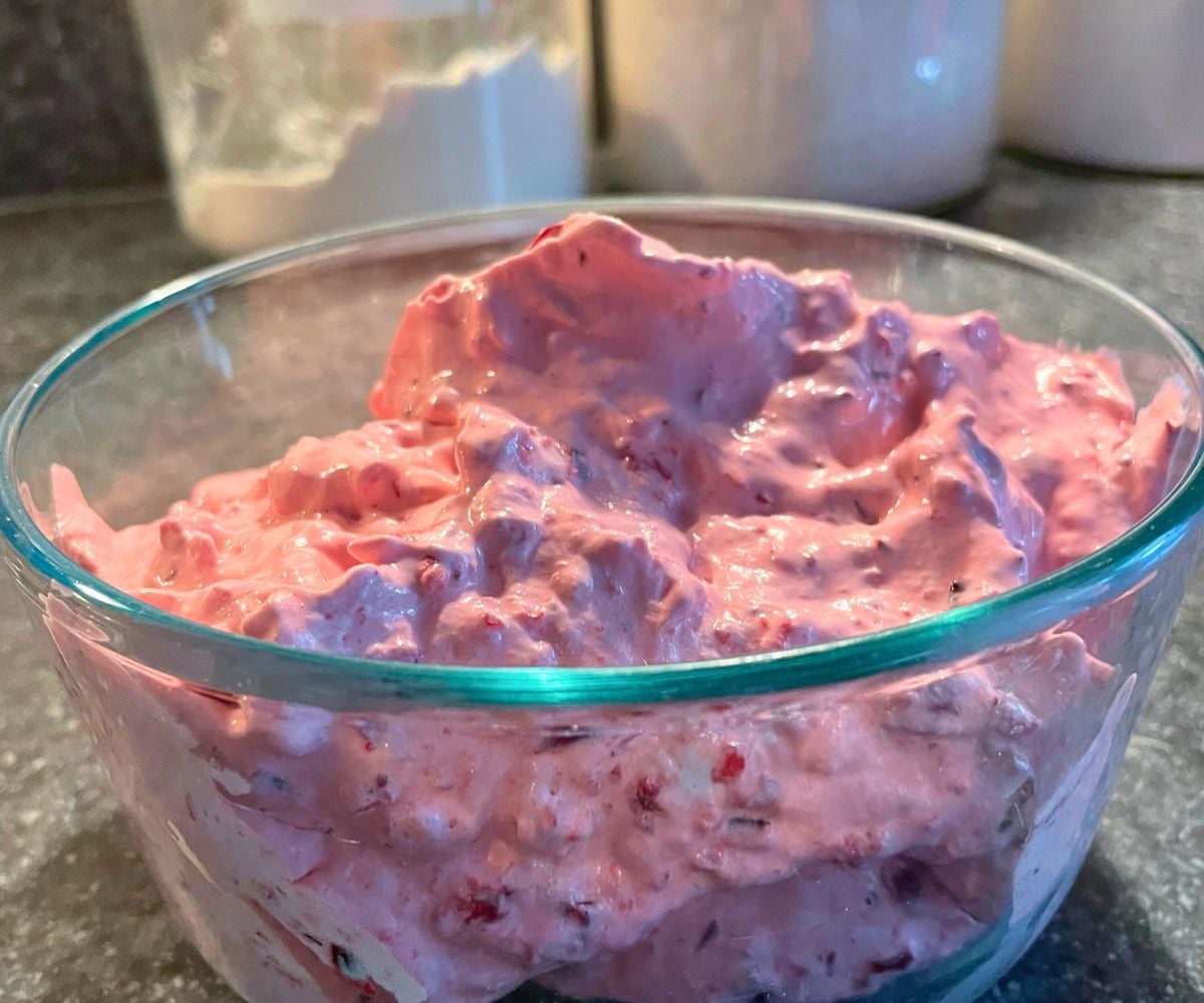 pink cranberry thanksgiving dessert salad in glass bowl