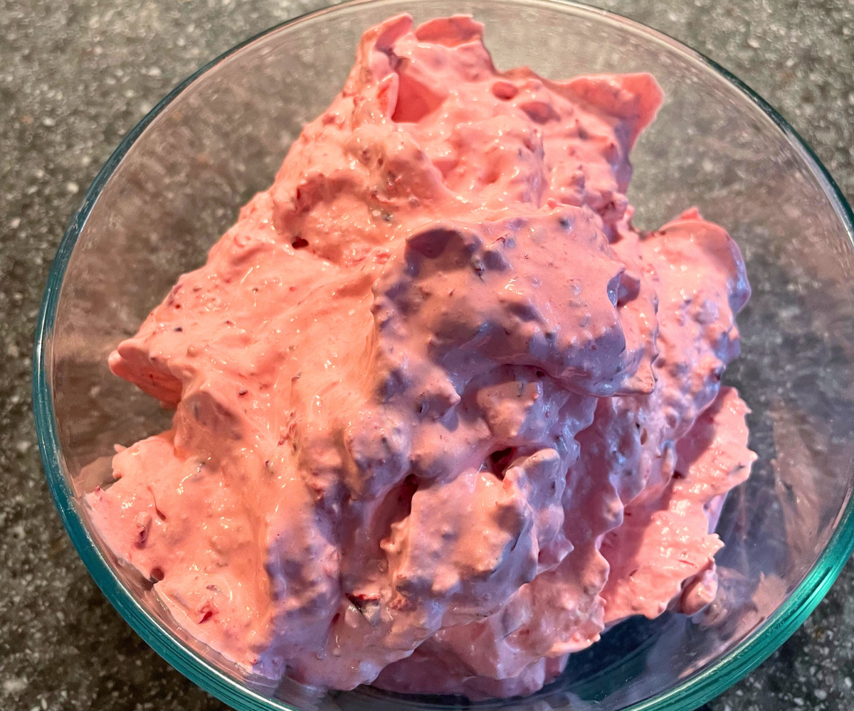 glass bowl full of colorful cranberry fluff no bake Thanksgiving dessert