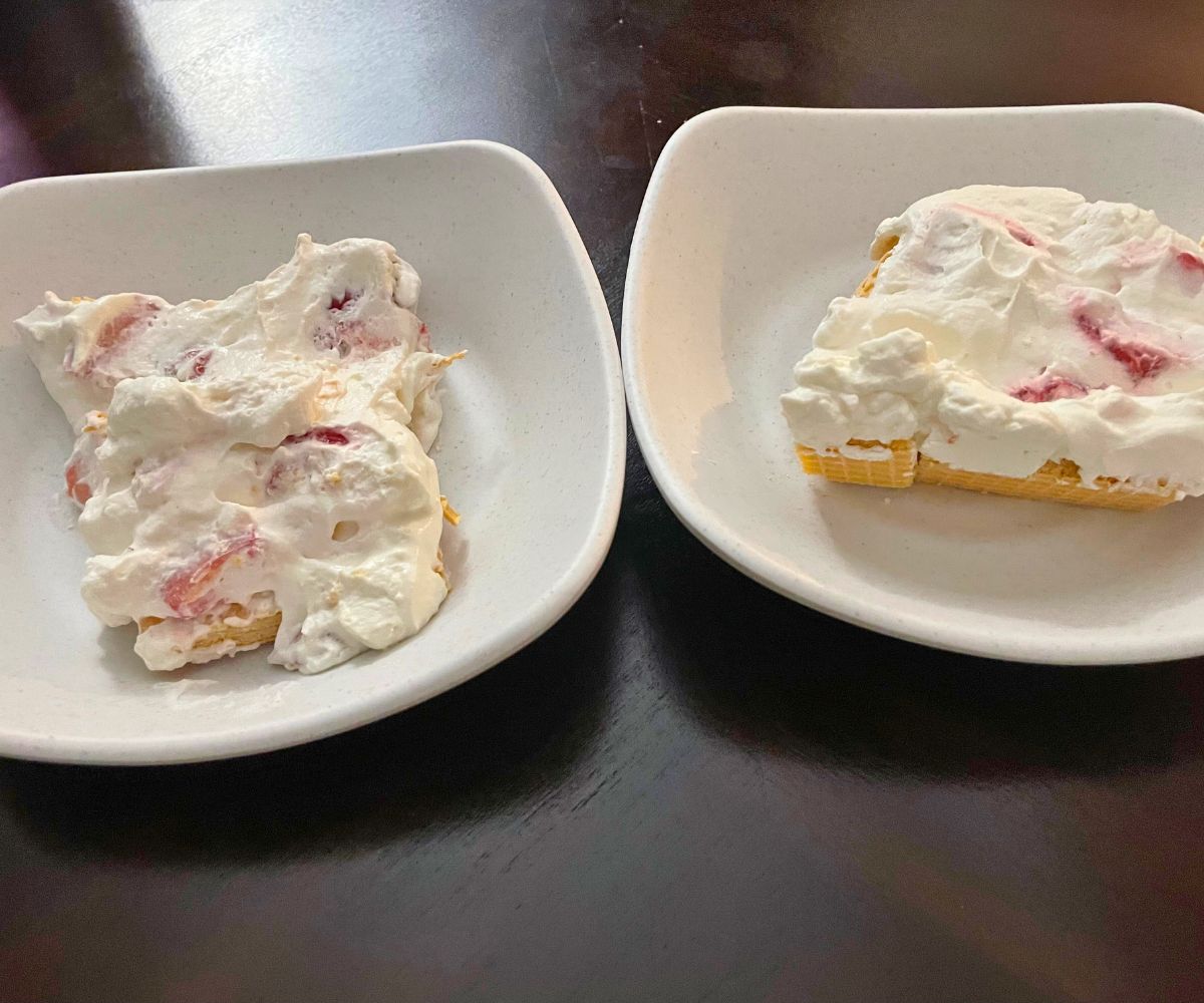 two plates with strawberry icebox cake helpings on them
