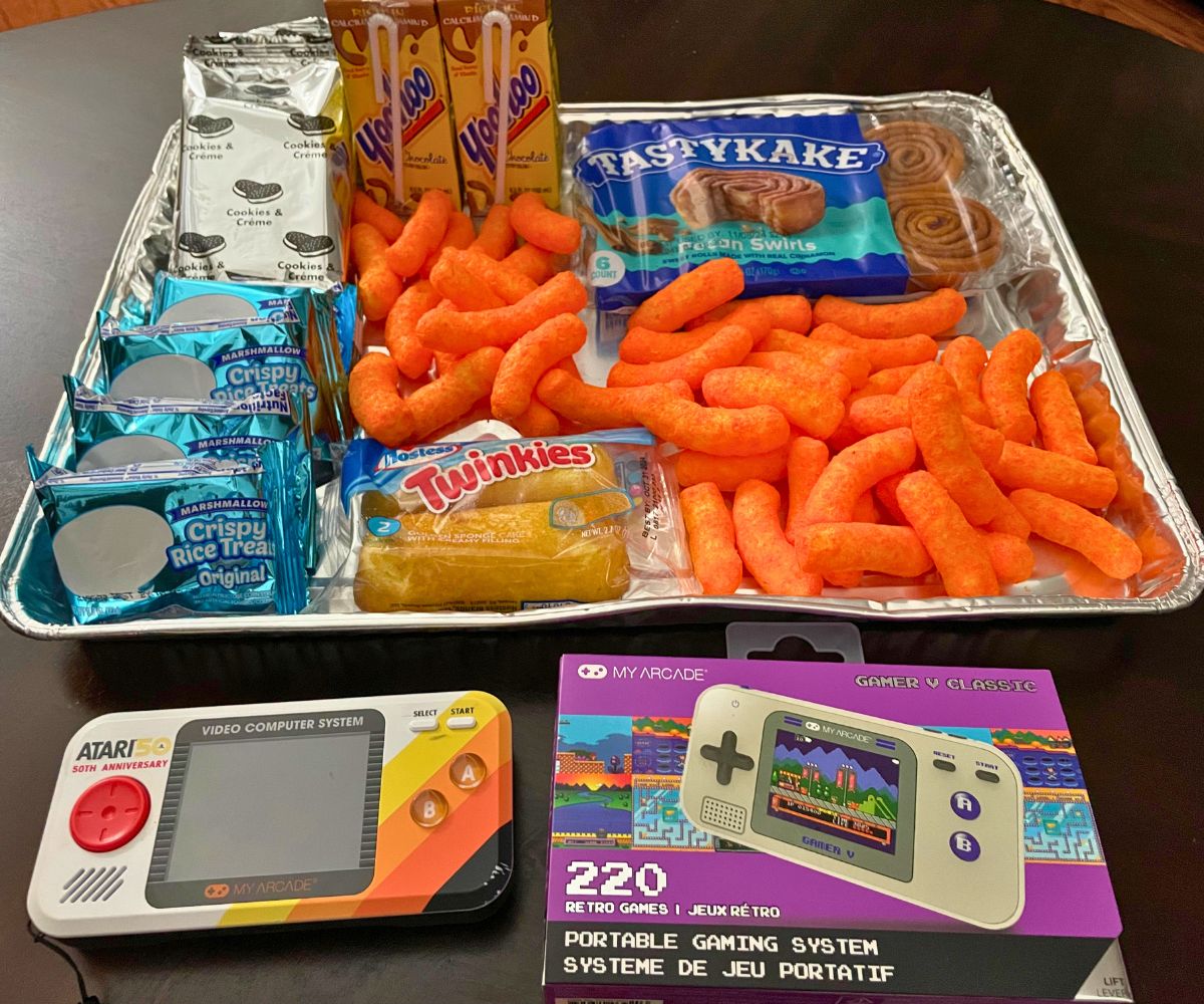 tray of junk foods from the Dollar Tree and two retro game devices