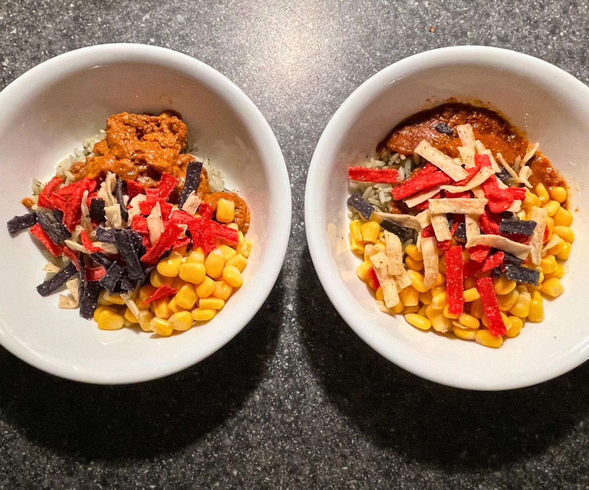two bowls filled with corn, lime and cilantro rice, chili con carne, and colorful tortilla strips