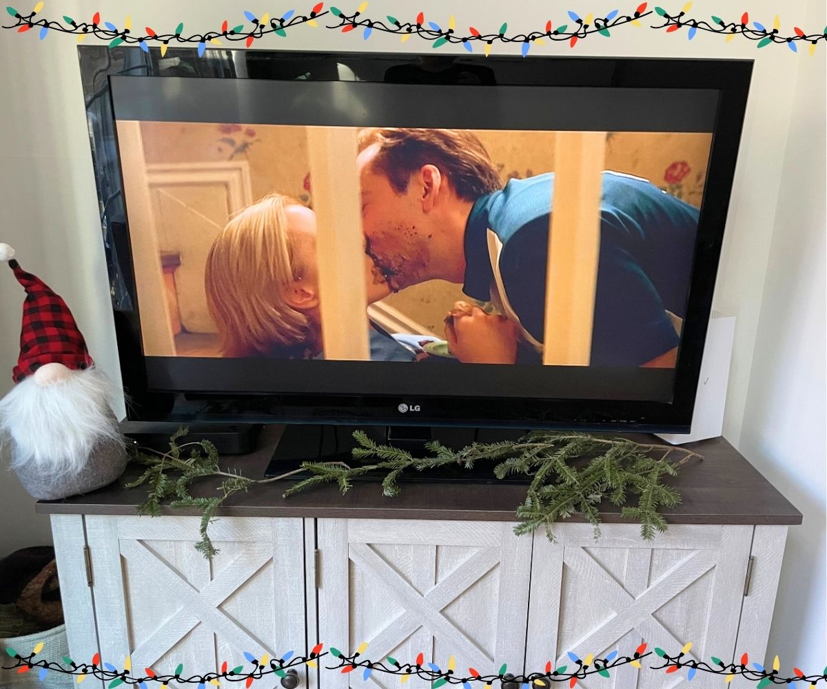 Nicholas Cage and Téa Leoni in middle of fun cake fight on stairs, kissing on TV with gnome in front