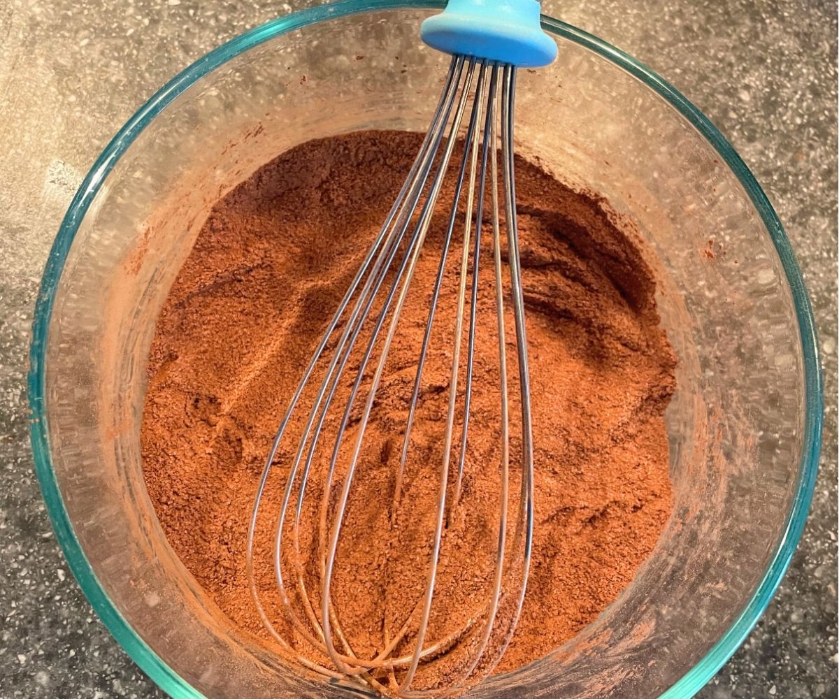 hot cocoa mixture in glass bowl with whisk